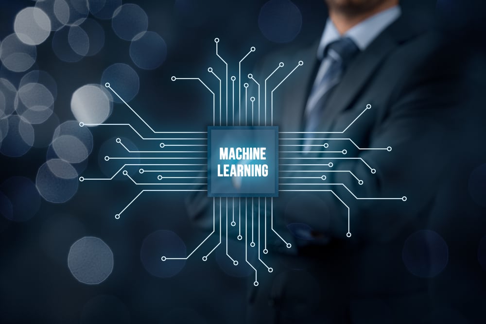Machine learning data analysis concept. Businessman or programmer with abstract symbol of a chip with text machine learning connected with data represented by points.