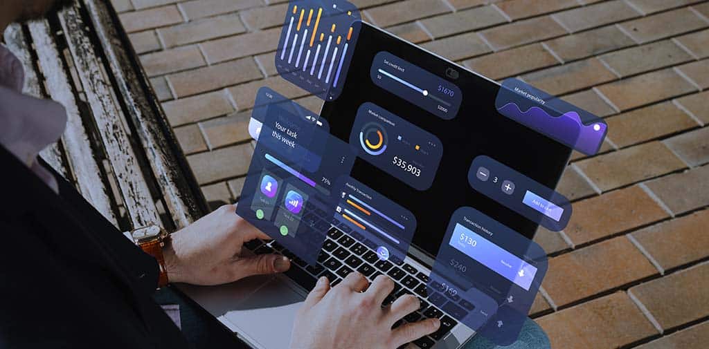 Profissional utilizando ferramentas de BI em um laptop, com painéis e gráficos interativos para análise de dados.