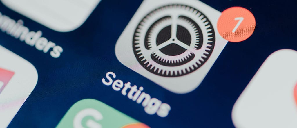 Imagem do ícone de configurações em um smartphone, representando ajustes e personalização na programação de aplicativos.