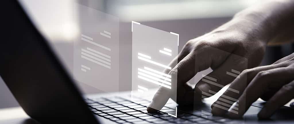 Profissional gerenciando máquinas virtuais no laptop, representando o uso do Citrix XenServer para administração de servidores.