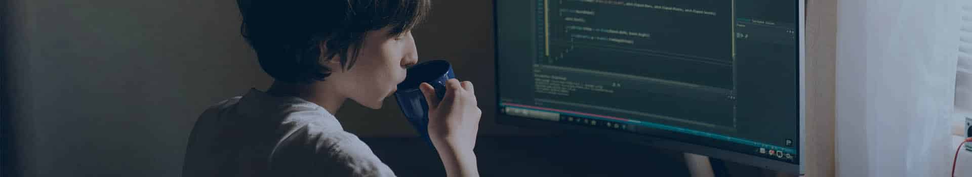 Jovem programador trabalhando em um ambiente iluminado, destacando a importância da arquitetura de software para sistemas eficientes.